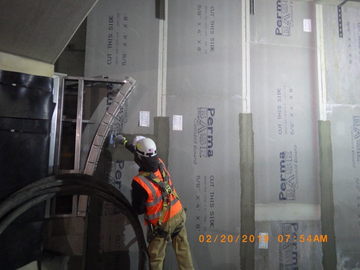 Sheetrock wall installation on a commercial construction site