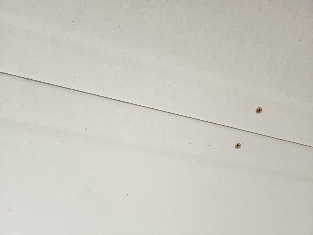 Close-up of plasterboard drywall showing tapered edges and joint detail